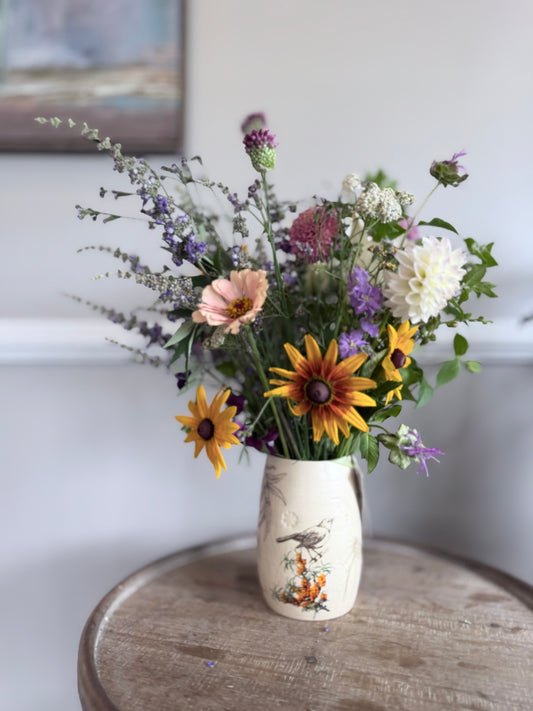 vase of wildflowers in a brightly lit room